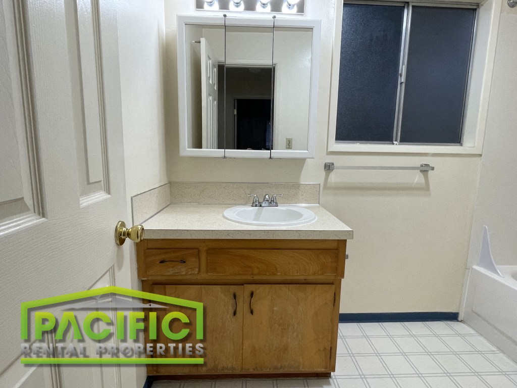 a small bathroom with a sink and a mirror