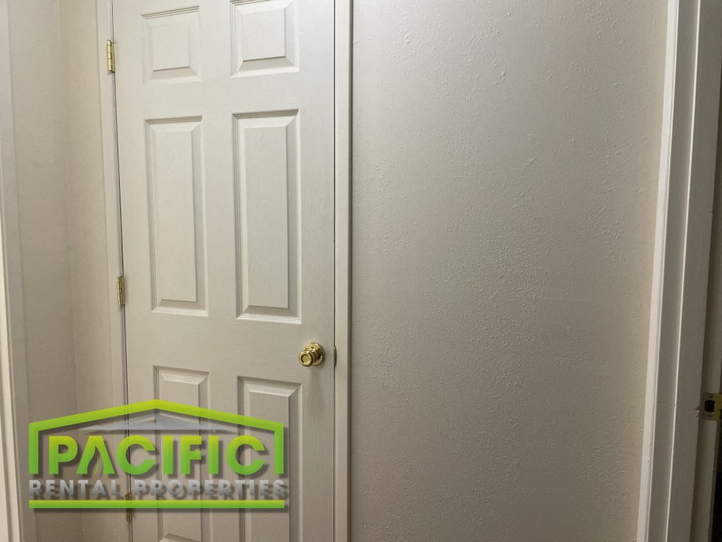 a white door next to a white wall with a pacitech logo on it