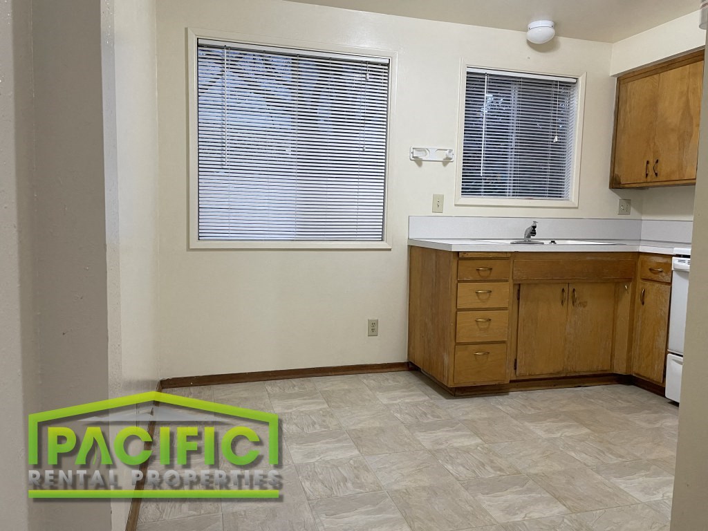 a small kitchen with a sink and a window