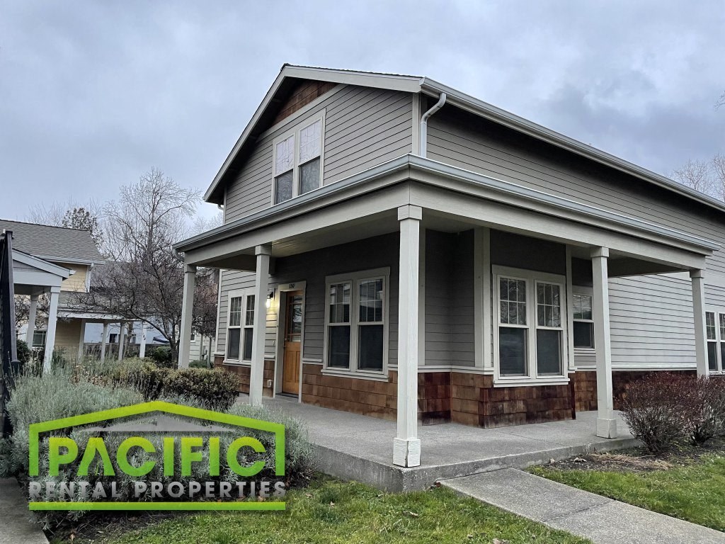 a house with a porch and a sign that reads pacific northwest properties