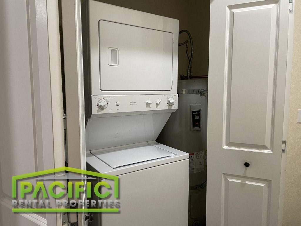 a small closet with a washer and dryer in it