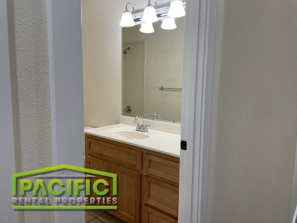 a full view of a bathroom with a sink and a mirror