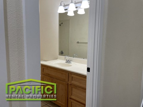 a full view of a bathroom with a sink and a mirror