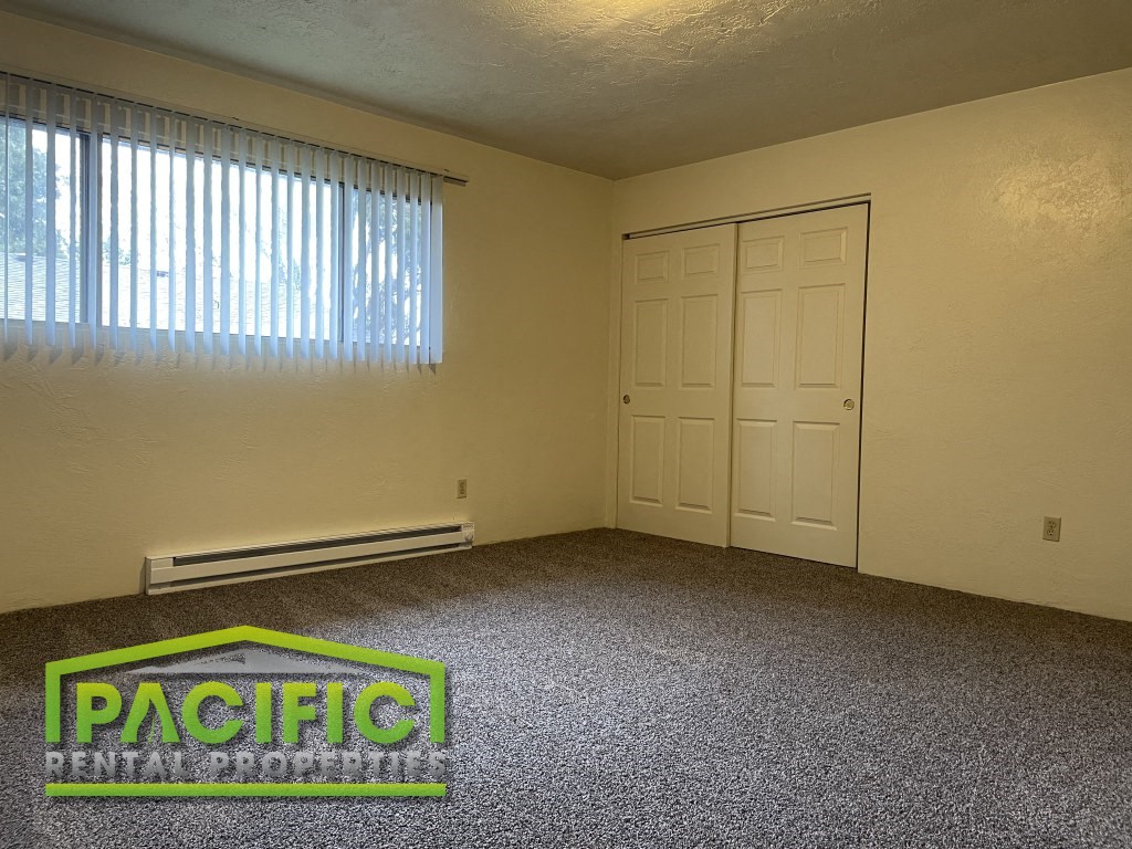 a empty room with a window and a door