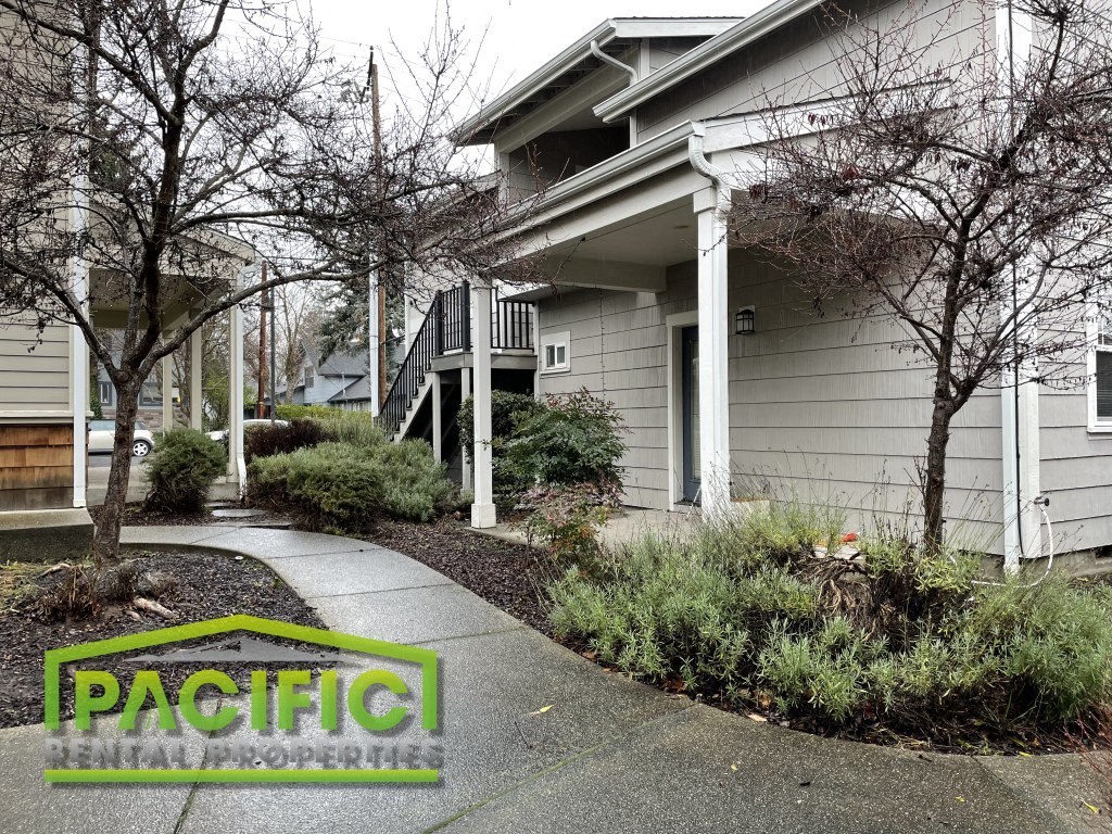 a house with a sidewalk in front of it