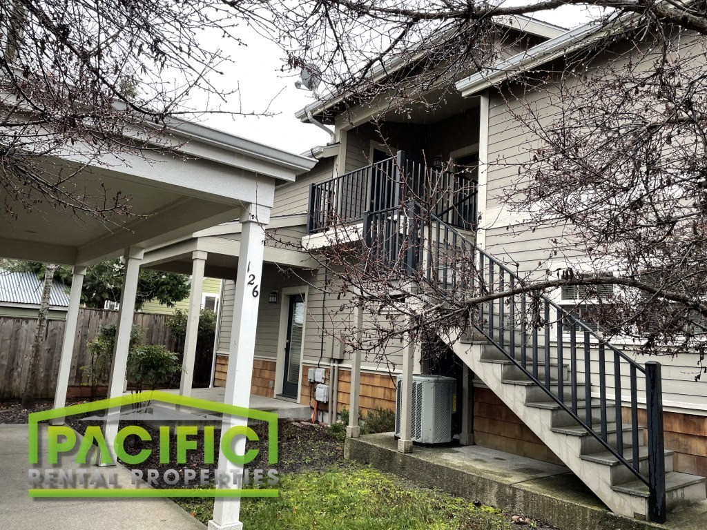 a remodeled house with a staircase and a front porch