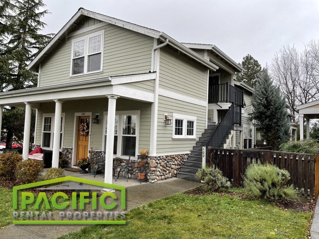 a renovated house with a front porch and stairs