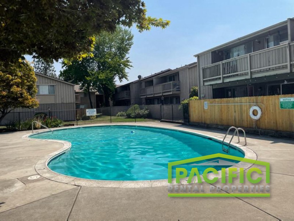 a swimming pool in front of an apartment building