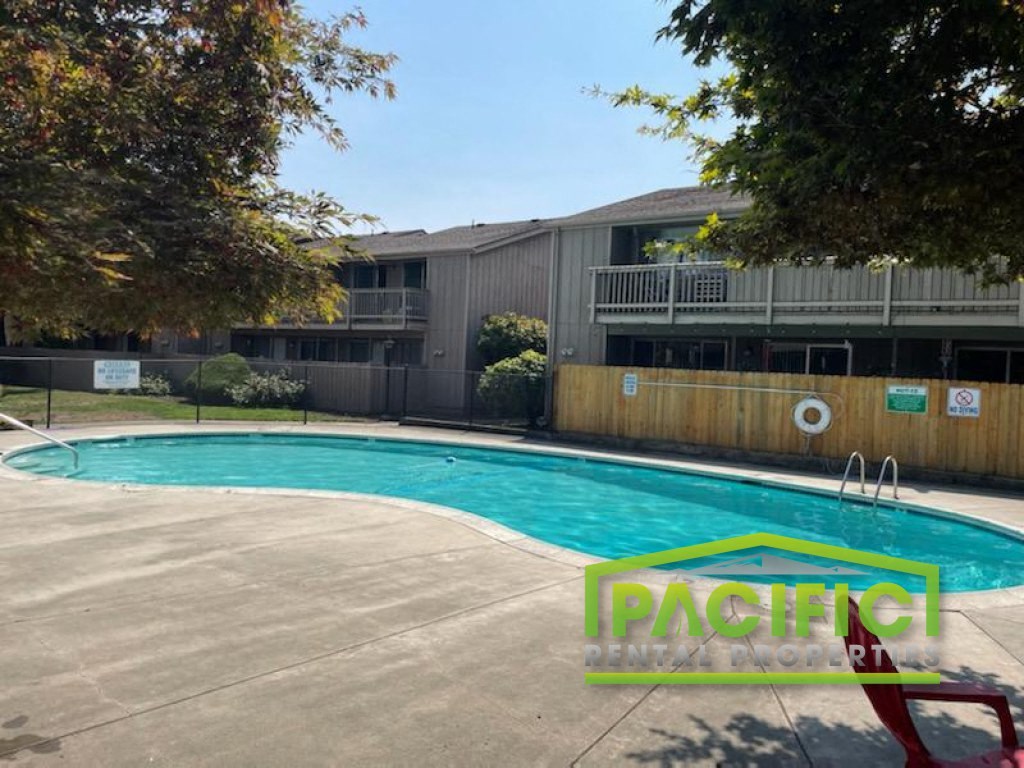 a swimming pool in front of an apartment building
