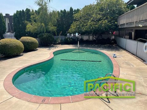 a swimming pool in a backyard next to a building