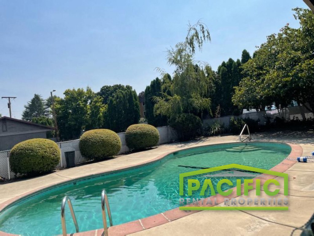 a swimming pool in the backyard of a house
