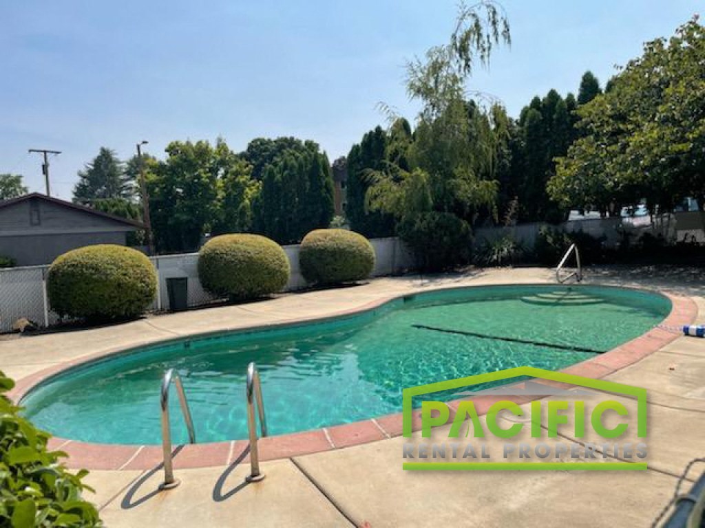 a swimming pool in the backyard of a house