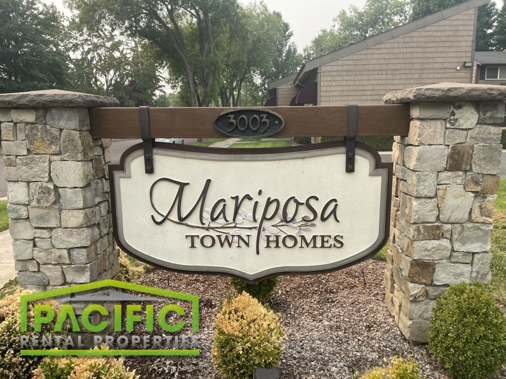 a sign that says homes on a stone wall