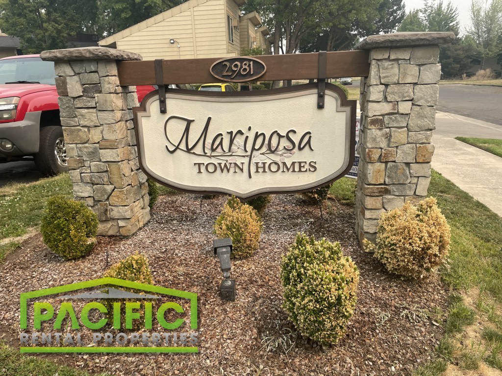 a sign homes in front of a driveway