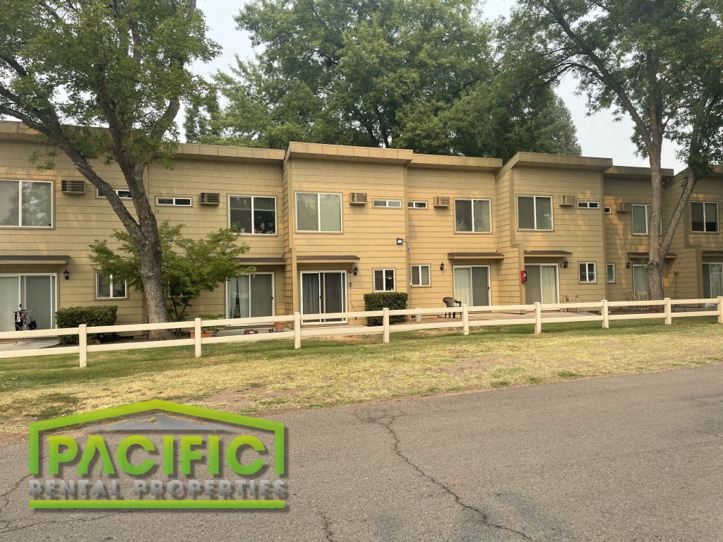 a large apartment building with a street in front