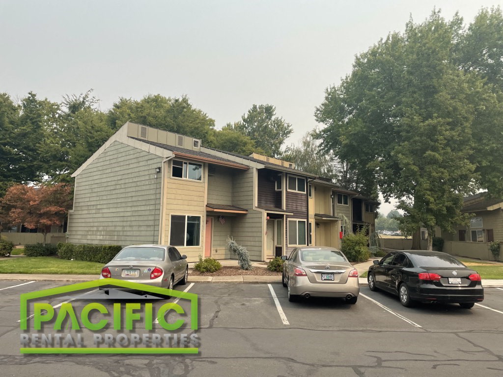 a house with cars parked in a parking lot