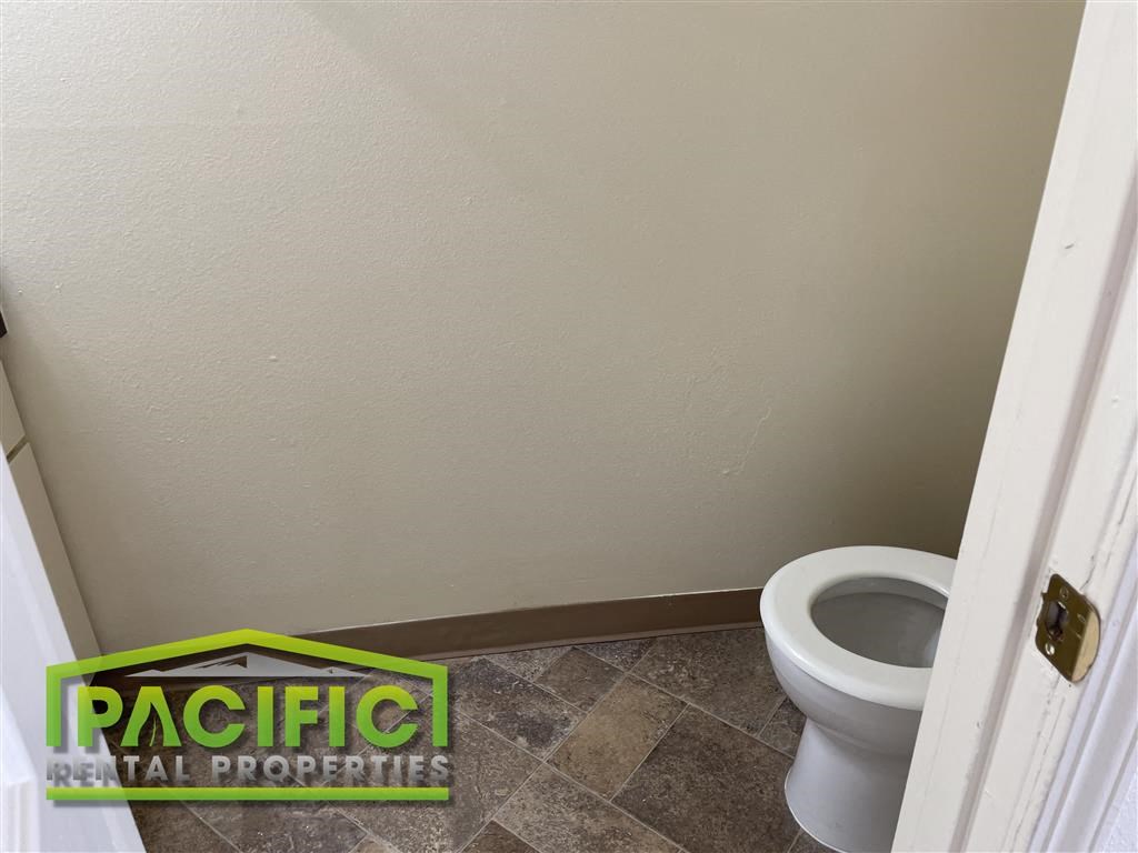 a bathroom with a toilet and a door