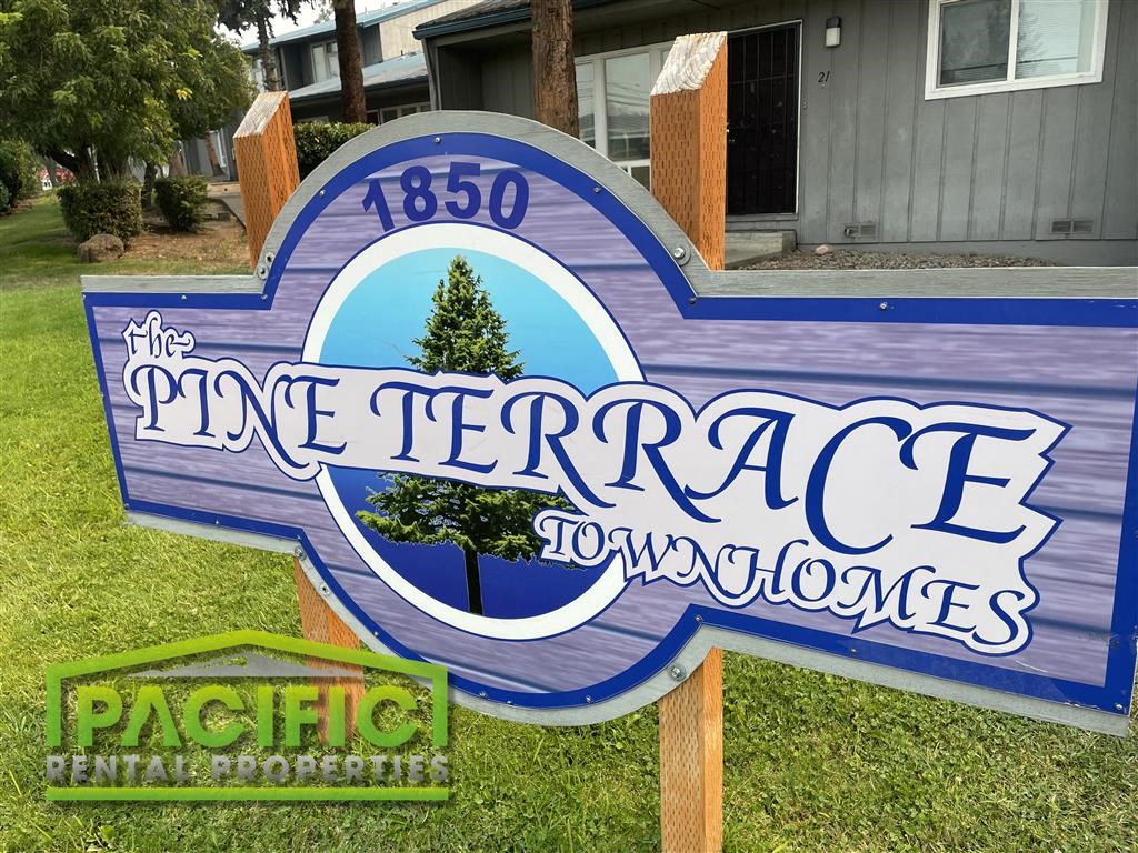 a street sign for the pine terrace to two doors