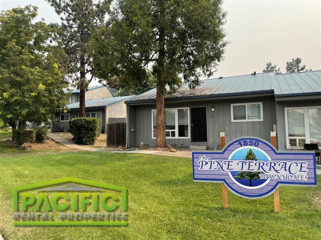 a neighborhood sign in front of a house