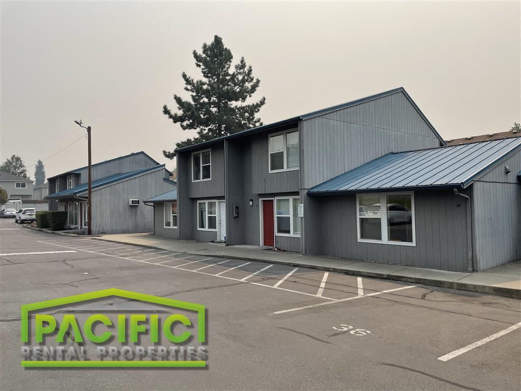 a commercial building with a parking lot in front of it