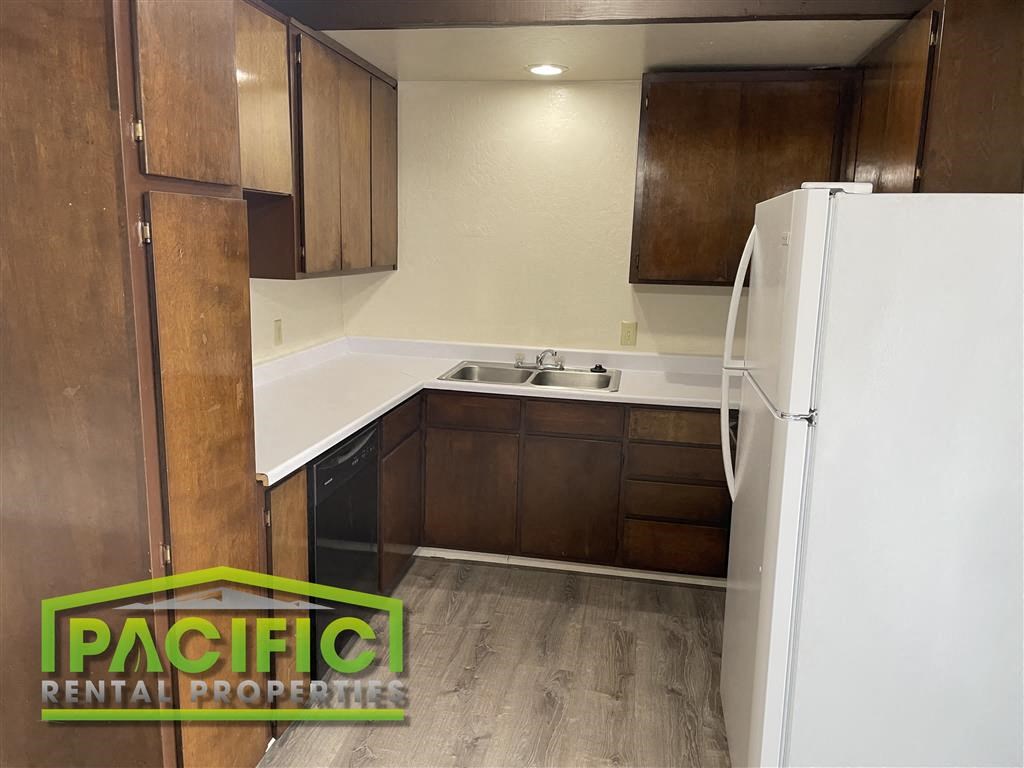 a small kitchen with a refrigerator and a sink