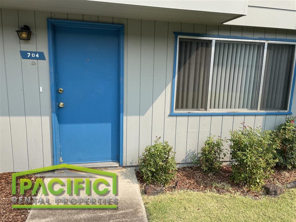 a blue door on the side of a house