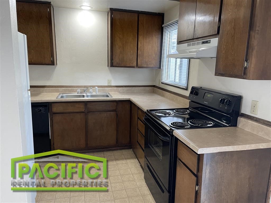a kitchen with a stove and a sink