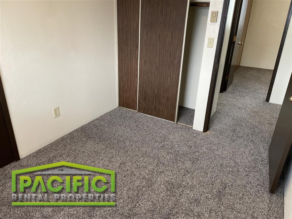 a carpeted hallway with a pacific logo on the floor
