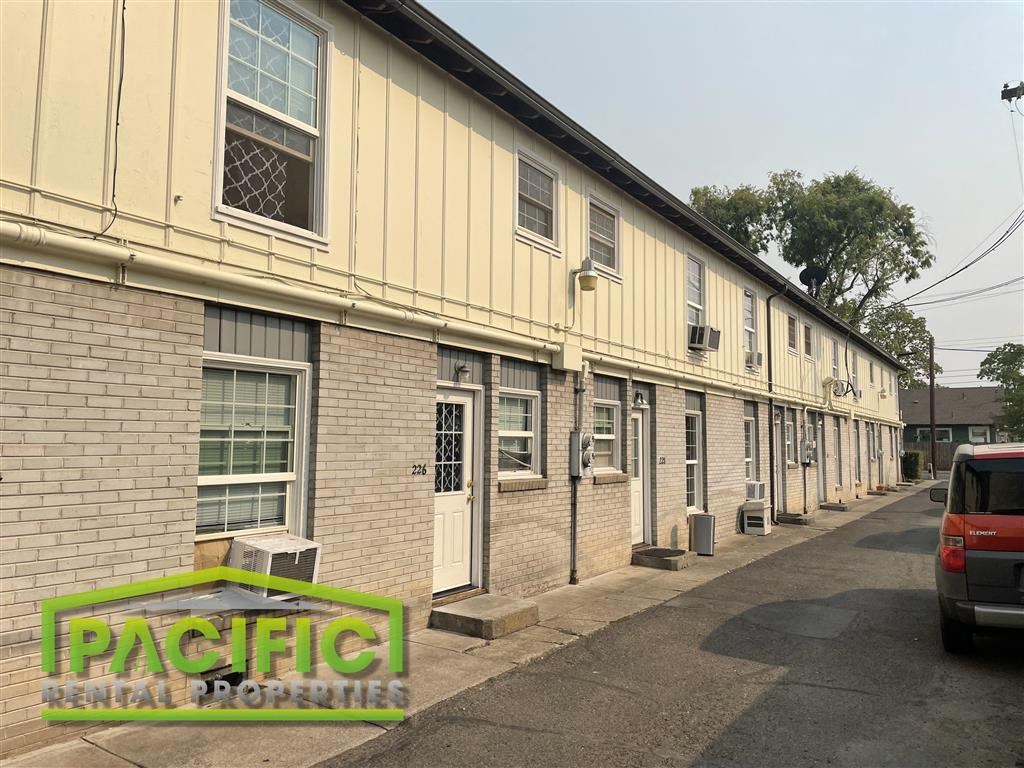 an old building with a car parked in front of it