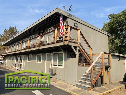 an apartment building with an flag on the balcony