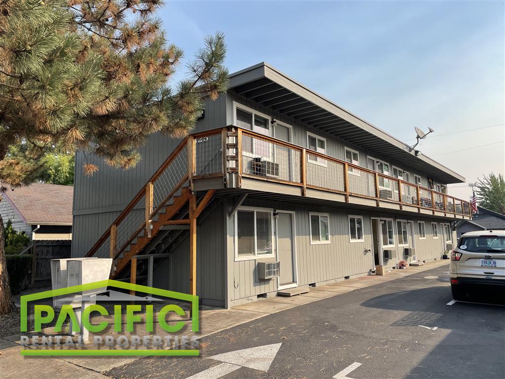 a building with stairs and a parking lot