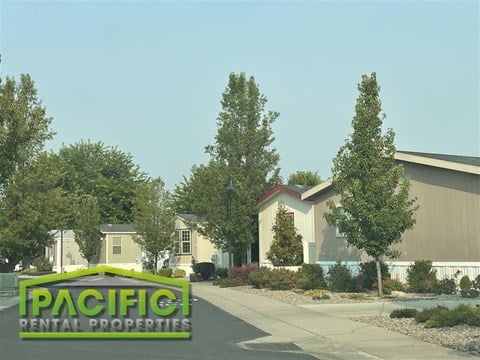 a building with a pacific rental properties sign in front of it