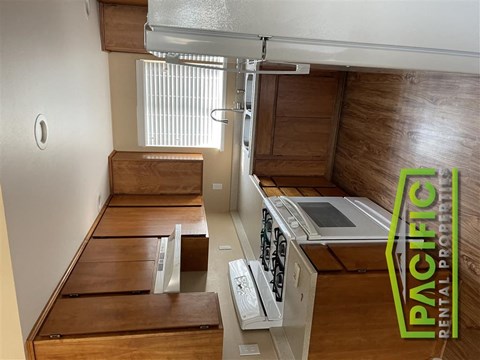 a kitchen with wooden cabinets and a stove top oven