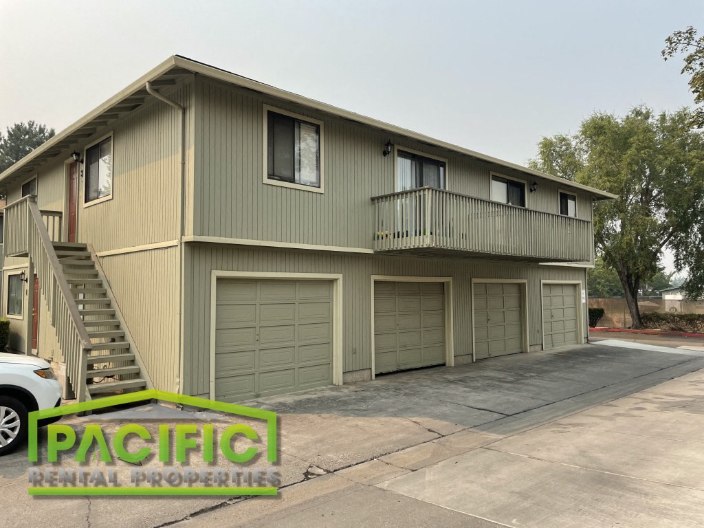 a home with a garage and a balcony on the side