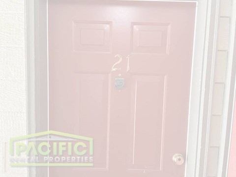 a pink door with a tag on it and a white door