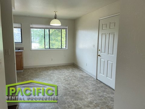 the living room of an empty house with a window