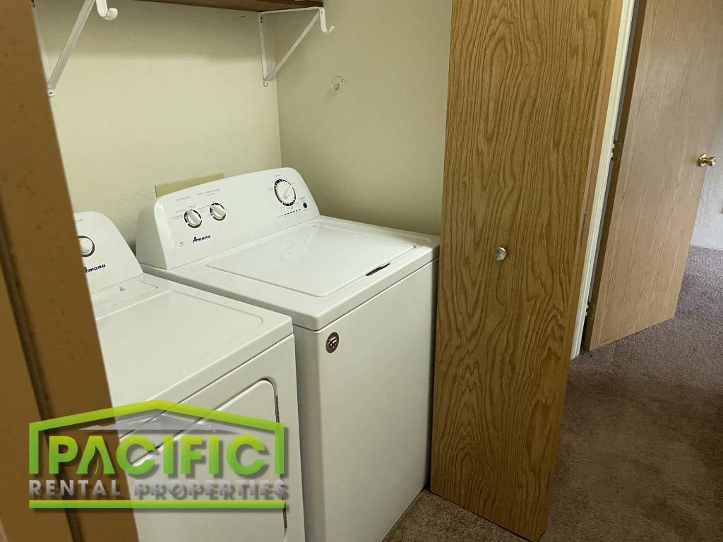 a washer and dryer in a room with a closet