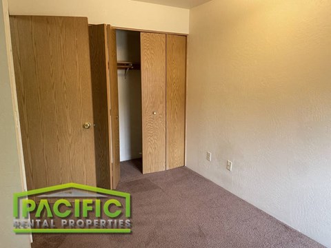 a empty room with a closet and an open door