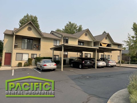 a building with cars parked in a parking lot