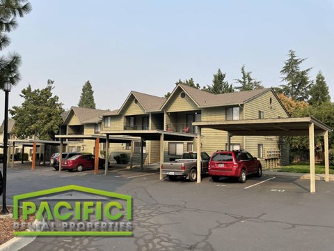 a parking lot with cars in front of a building