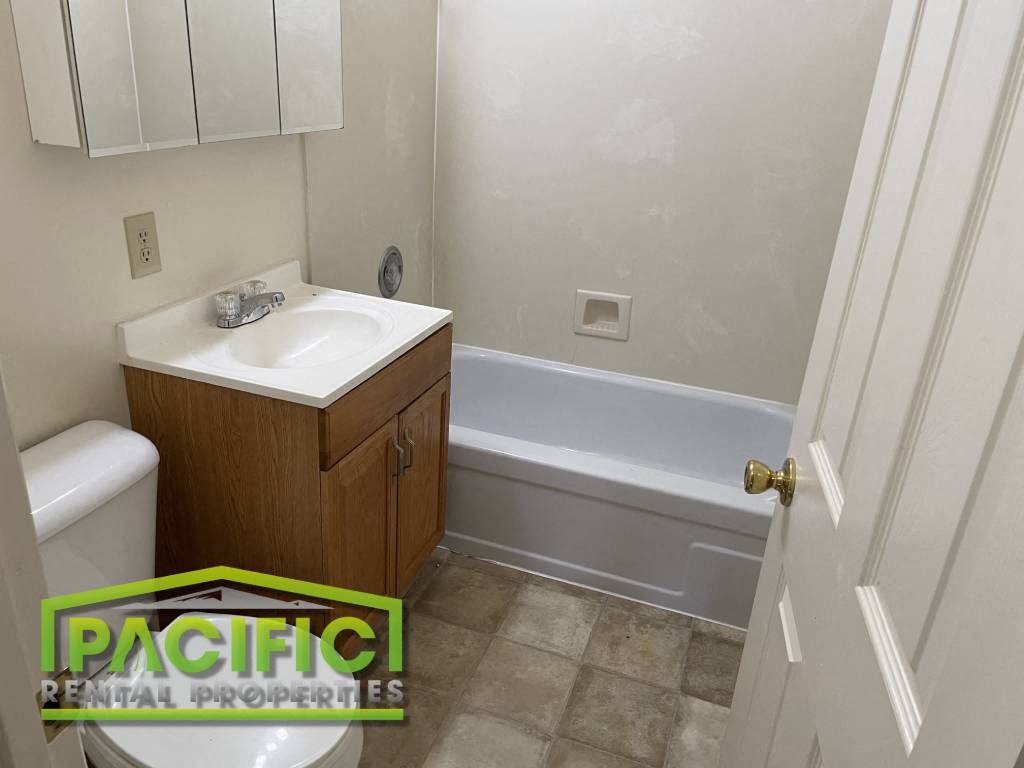 a bathroom with a sink and a toilet and a bath tub