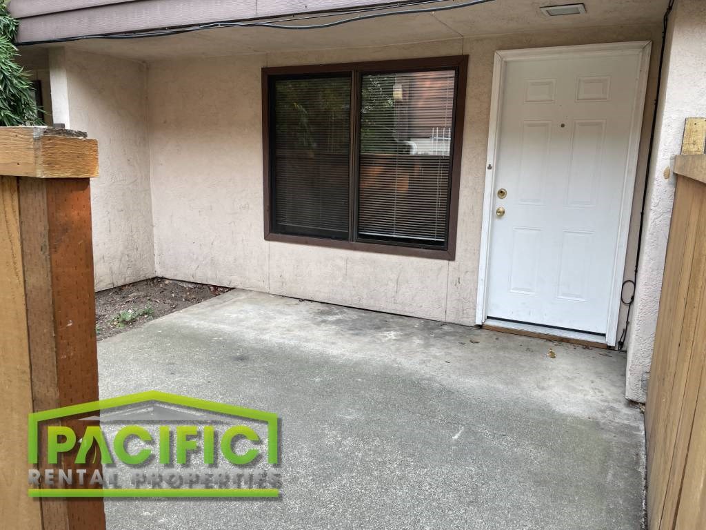 a front porch of a house with a white door