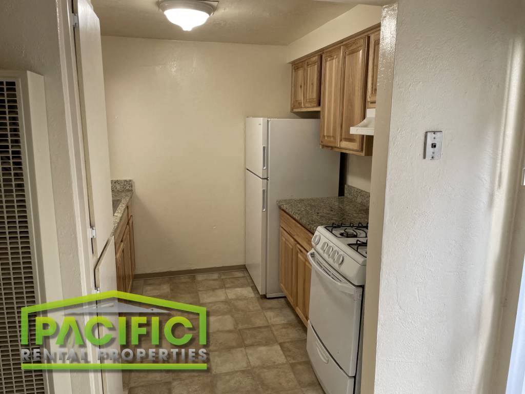 a kitchen with a stove and a refrigerator