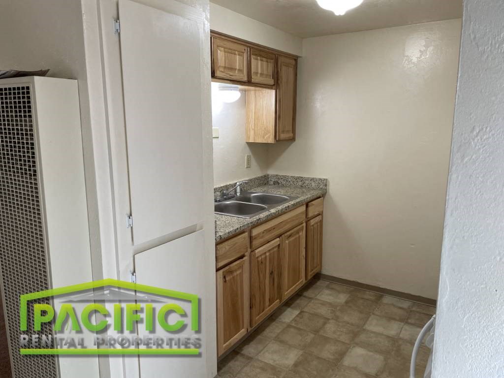 a small kitchen with a refrigerator and a sink