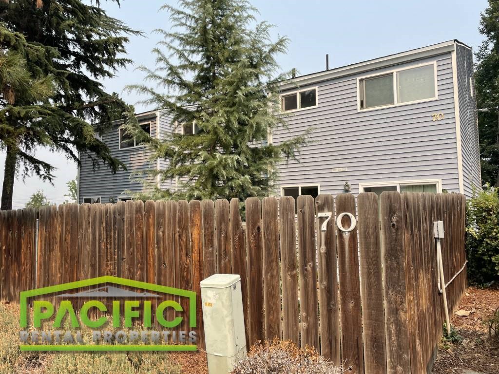 a wooden fence in front of a house
