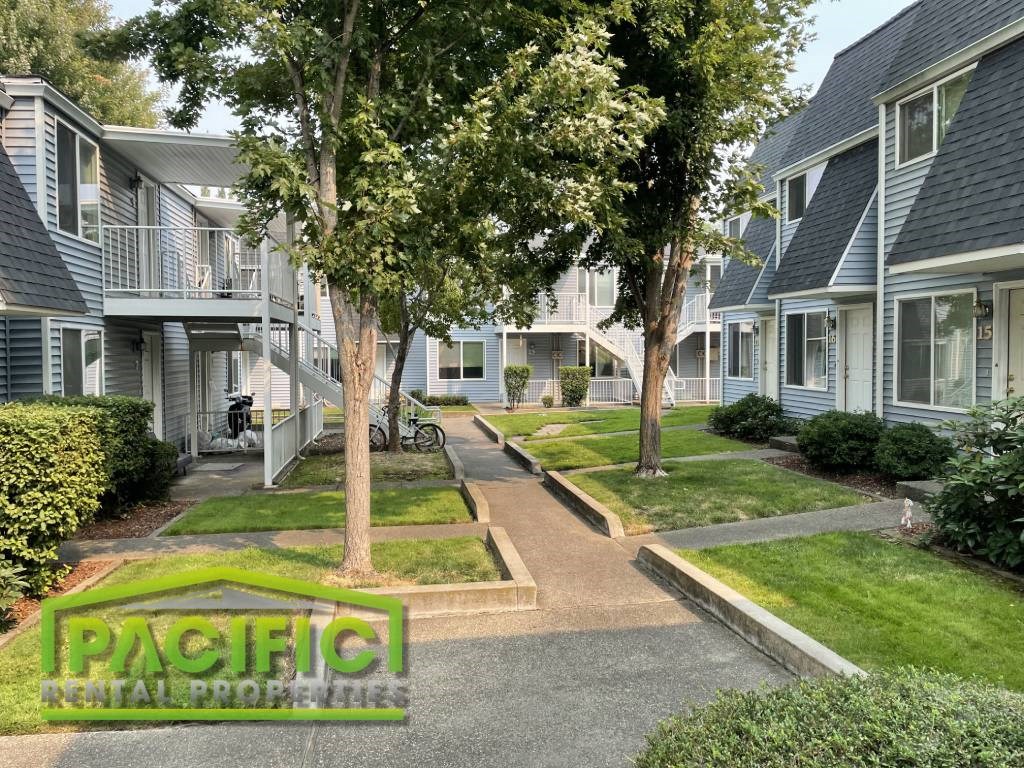 a row of town houses with trees in front of them
