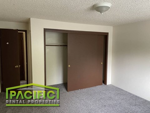 a bedroom with a closet and a wardrobe