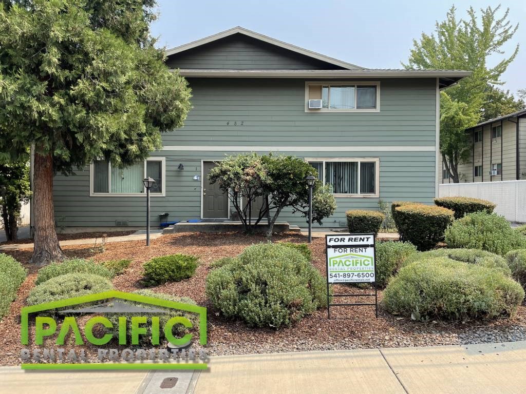 a house with a for sale sign in front of it