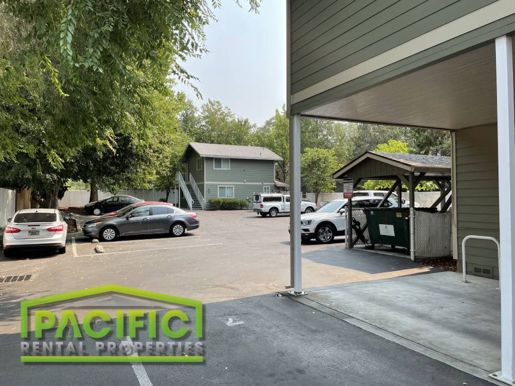a gas station with cars parked in a parking lot