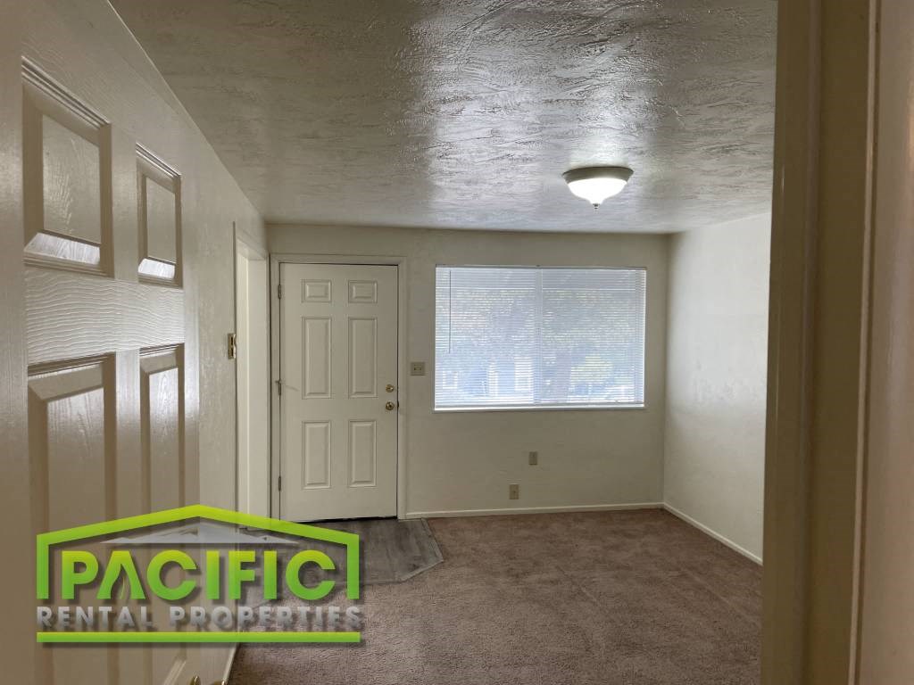 the interior of an empty room with a closet and a window
